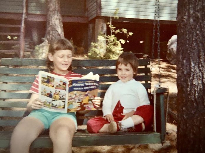 The author Suzanne McDonough (right) with her sister Cathy on their favourite swing in front of their family's Kawartha cottage in the 1960s. Because of the COVID-19 pandemic, the McDonough family has been unable to visit the beloved cotttage the family has owned since the 1930s. (Photo courtesy of Suzanne McDonough)