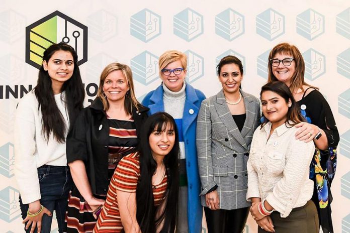 Manjit Minhas (second from right, back row) in March 2020 with local business people Dawn Hennessey (second from left, back row), Rhonda Barnet (centre, back row), and Sofie Andreou (right, back row), founders of FemSteamPtbo, an organization supporting  young females in the Peterborough area to pursue education and career options in STEAM and skilled trades.  Minhas, a Canadian entrepreneur, venture capitalist, and self-described beer baroness who is one of the celebrity investors on CBC Television's popular Dragons' Den series, was the guest speaker at the Innovation Cluster’s Electric City Talks series with a talk entitled "Empowering Women: Achieving Business Success in Male-Dominated Industries".  (Photo courtesy of Innovation Cluster - Peterborough and the Kawarthas)