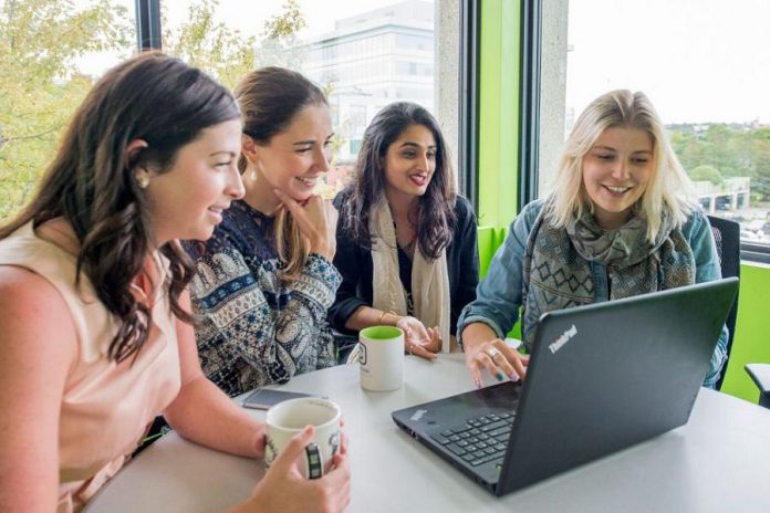 Young female entrepreneurs pictured in pre-pandemic days in the Innovation Cluster's The Cube business incubator in downtown Peterborough. To accommodate the impacts of COVID-19, the Innovation Cluster's new "Women Breaking Barriers" business accelerator program will be offered virtually and will only take six months to complete. Thanks to a grant from the Ontario Trillium Foundation, the program is offered at no cost to participants. Applications for the first cohort are due on August 27, 2020 at noon. (Photo courtesy of Innovation Cluster - Peterborough and the Kawarthas)