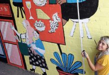 Peterborough illustrator Kathryn Durst at work on her mural in the alleyway of the Commerce Building in downtown Peterborough. The mural, commissioned by the First Friday Peterborough volunteer committee and Commerce Building owner Ashburnham Realty, will be celebrated from 6 to 10 p.m. on Friday, September 4, 2020. (Photo: First Friday Peterborough / Facebook)