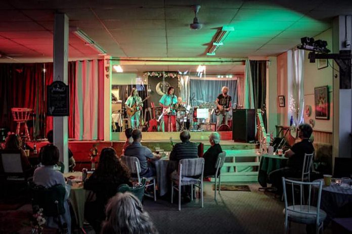 At The Keene Centre for the Arts, a plexiglass shield separates the performers from the physically distanced tables in the audience. (Photo courtesy of The Keene Centre for the Arts)