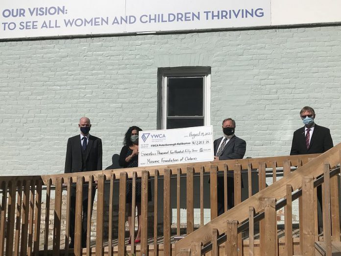 Tom Mortlock, District Deputy Grand Master of Peterborough (second from right) presents a cheque for $17,253.25 to YWCA Peterborough Haliburton's major gifts officer Ria Nicholson, on behalf of the Peterborough District Masonic Association, in support of the YWCA Crossroads Shelter for women and children. Mortlock was accompanied by the association's district fundraising project chairman Danny McLaughlin (left) and the district secretary Philip Lake (right). (Photo courtesy of YWCA Peterborough Haliburton)