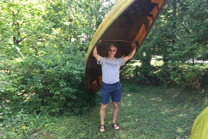 Paul Plant, who lost his wife Karen Hoffman to ovarian cancer last year, raised almost $4,000 for the 2019 Ovarian Cancer Canada Walk of Hope in Peterborough by committing to carry his canoe on his shoulders for five kilometres. For the 2020 virtual walk, Plant will be carrying his canoe from downtown Peterborough into East City and back while volunteers collect donations. (Photo courtesy of Paul Plant)