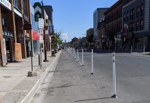Vertical posts (bollards) were installed on selected streets in downtown Peterborough in June 2020 to create additional pedestrian space for physical distancing and allow for the expansion of sidewalk patios. (Photo: Bruce Head / kawarthaNOW.com)