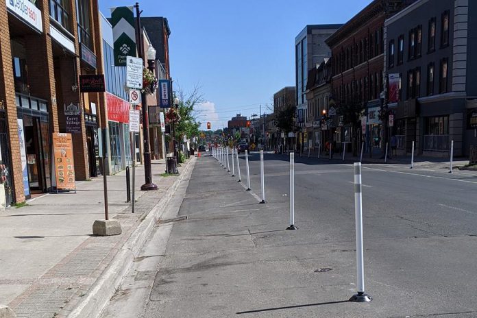 Vertical posts (bollards) were installed on selected streets in downtown Peterborough in June 2020 to create additional pedestrian space for physical distancing and allow for the expansion of sidewalk patios. (Photo: Bruce Head / kawarthaNOW.com)