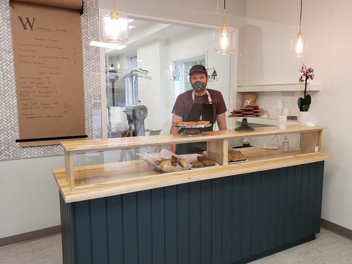 Hard Winter Bakery co-owner Graham Thoem behind the counter at Peterborough's newest bakery, which opened in mid-October. (Photo: Jeannine Taylor / kawarthaNOW.com)