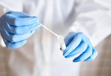 A COVID-19 test swab in a laboratory. (Stock photo)