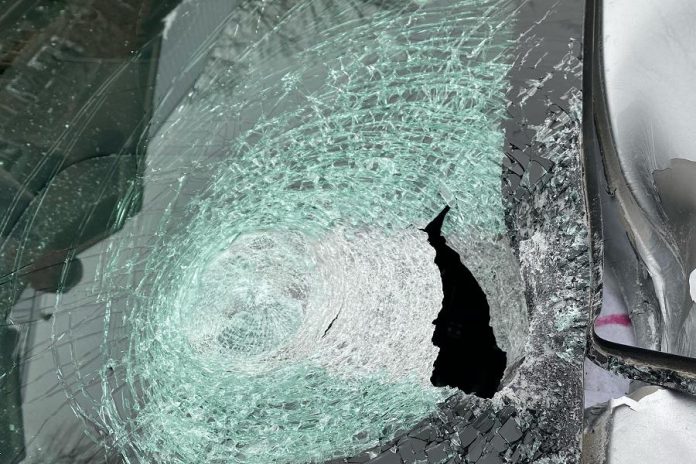 The windshield damage caused by the five-pin bowling ball. The complainant sustained minor injuries that did not require medical attention.  (Police-supplied photo)