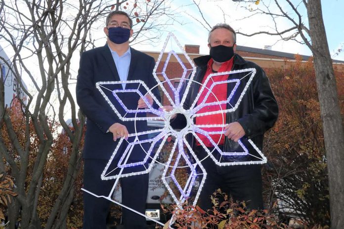 Peterborough-Kawartha MPP Dave Smith and Peterborough DBIA executive director Terry Guiel with one of the new new decorative holiday lights to be installed in downtown Peterborough. (Supplied photo)