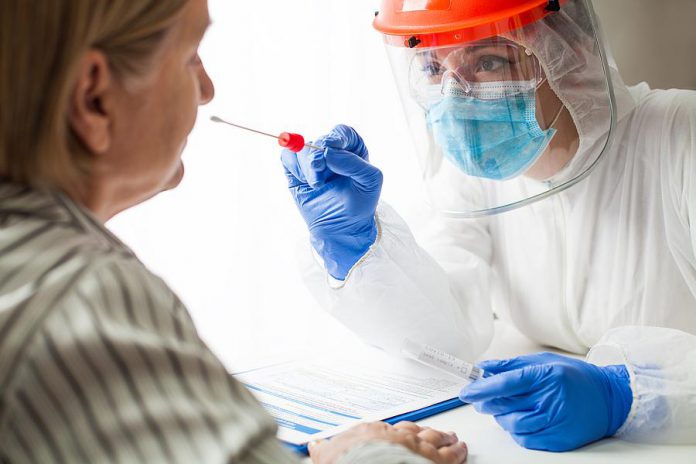 A swab test bring completed on a patient. (Stock photo)