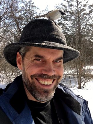 As well as learning to feed chickadees from your hand, you can even put seeds in your hat to attract them, as GreenUP's Leif Einarson demonstrates. (Photo: Leif Einarson)