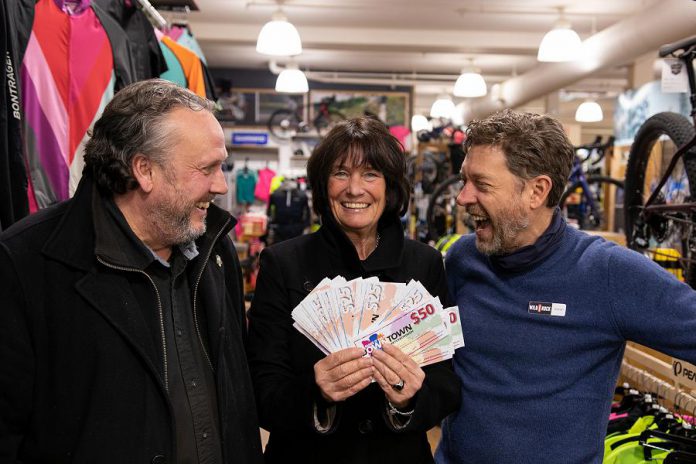 Karen Procyk of Peterborough collected $1,500 in "downtown money" in January 2020 after her Holiday Shopping Passport was drawn at the culmination of the annual initiative by the Peterborough Downtown Business Improvement Area (DBIA) to encourage people to shop local. Also pictured is DBIA executive director Terry Guiel (left) and Wild Rock Outfitters co-owner Kieran Andrews. (Photo courtesy of Peterborough DBIA)