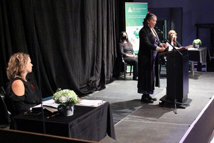 Lisa Dixon, owner of Black Honey in downtown Peterborough, speaks during the 2020 Junior Achievement Business Hall of Fame at The Venue in downtown Peterborough on November 5, 2020. Also pictured at the COVID-safe event are emcees Michelle Ferreri (left) and Monika Carmichael (far right), who is also JA-NEO's Business Hall of Fame Chancellor. (Photo courtesy of Junior Achievement - Northern and Eastern Ontario)