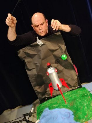 Brad Brackenridge flying a rocket ship in Planet 12 Productions produciton of "Santa Claus Conquers the Martians" in December 2019  at The Theatre On King in downtown Peterborough. (Photo: Derek Weatherdon)