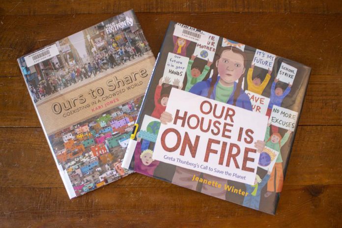 Librarians at the Peterborough Public Library recommend these two children's titles: "Ours to Share" also contains a list of several useful resources, and "Our House is on Fire" is a powerful reminder that one person can make a difference. (Photo: Leif Einarson)