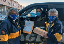 Rotarians Lynne Chant and Dawn Straka provide items to a successful bidder in the pick-up area after the Rotary Club of Peterborough Kawartha's annual Christmas auction, which raised $18,622 for YES Shelter for Youth & Families. (Photo courtesy of Rotary Club of Peterborough Kawartha)