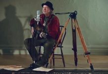 Neil Young performing 'Comes a Time' at an empty Coronation Hall in Omemee. He is making the film of his 2017 'Hometown' concert in Omemee, directed by his wife Daryl Hannah, available for free on his website during the month of December. (Screenshot)