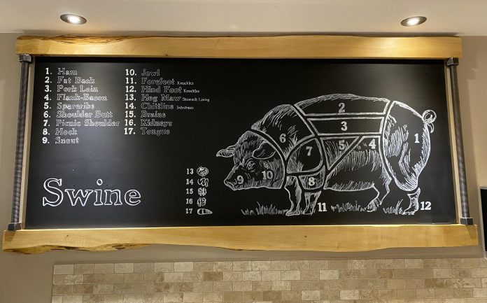 A chalkboard at Primal Cuts showing all the cuts of meat and organ meats from swine. As a nose-to-tail butcher, owner George Madill tries to use all the meat from an animal, including the bones to make broths and stocks. (Photo courtesy of Primal Cuts)