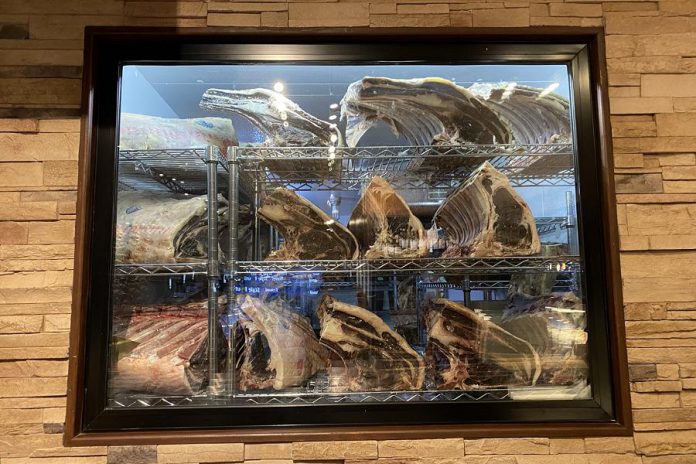 At Primal Cuts, there are two coolers with large windows where you can see whole lambs, pigs, and cuts of beef hanging and also witness the dry-aging process. One of the shop's walls is actually transparent, with a glass pane that looks into the cutting room, dubbed "The Tank".  (Photo courtesy of Primal Cuts)