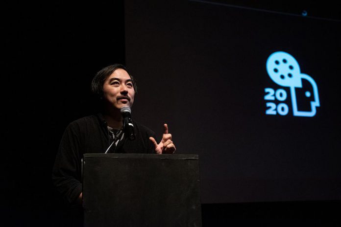 Acclaimed Toronto filmmaker Yung Chang speaking at Market Hall in downtown Peterborough during the 2020 ReFrame Film Festival. While there will be no in-person events at the 2021 ReFrame Film Festival, the festival will still feature virtual filmmaker talks, panel discussions, workshops, and more. (Photo: Tristan Peirce)