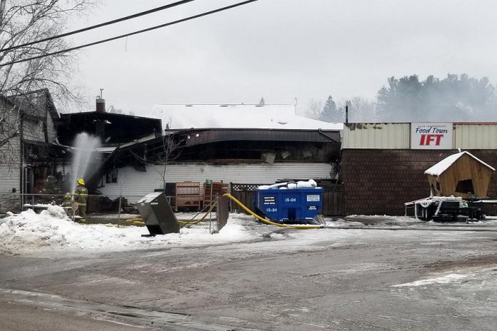 Members of the North Kawartha Fire Department continue to extinguish a fire at Sayers Foods in Apsley that happened early in the morning of December 5, 2020. The building was severely damaged in the fire and will need to be demolished, according to North Kawartha mayor Carolyn Amyotte. Until Sayers Food is able to rebuild, residents of the village of Apsley and the surrounding area will need to travel to Bancroft for groceries. (Photo: OPP)