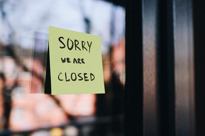 A business with a closed sticky on the door. (Stock photo)