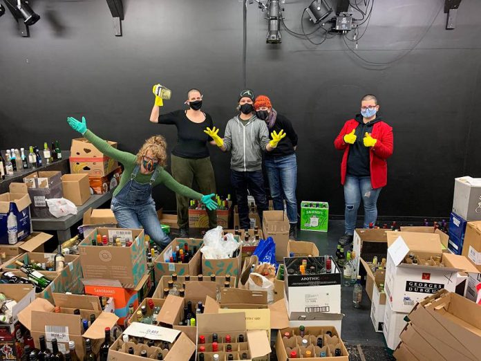Over the past month, Peterborough residents and businesses have donated tens of thousands of empty alcohol bottles and cans to The Theatre On King in downtown Peterborough. Volunteers have sorted and deposited the empties, raising more than $3,000 to date for Peterborough's only black-box theatre, which has been forced to remain closed since the pandemic began. Pictured from left to right: Sarah McNeilly, Shannon McKenzie, Ryan Kerr, Kate Story, and Eryn Lidster. (Photo: Julie Gagne)
