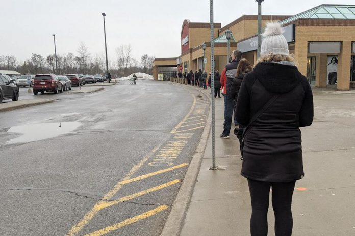 Shoppers line up outside Morello's Your Independent Grocer in Peterborough as the store controls capacity limits as required during the province-wide shutdown. Peterborough Public Health is urging residents to only leave their homes for essential reasons with January on track to see the most cases reported in a monthly period during the pandemic. (Photo: Bruce Head / kawarthaNOW.com)