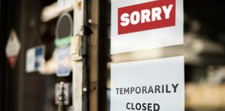 A "temporarily closed" sign on a store window. (Stock photo)