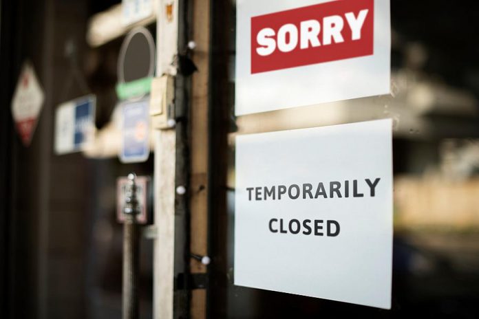 A "temporarily closed" sign on a store window. (Stock photo)