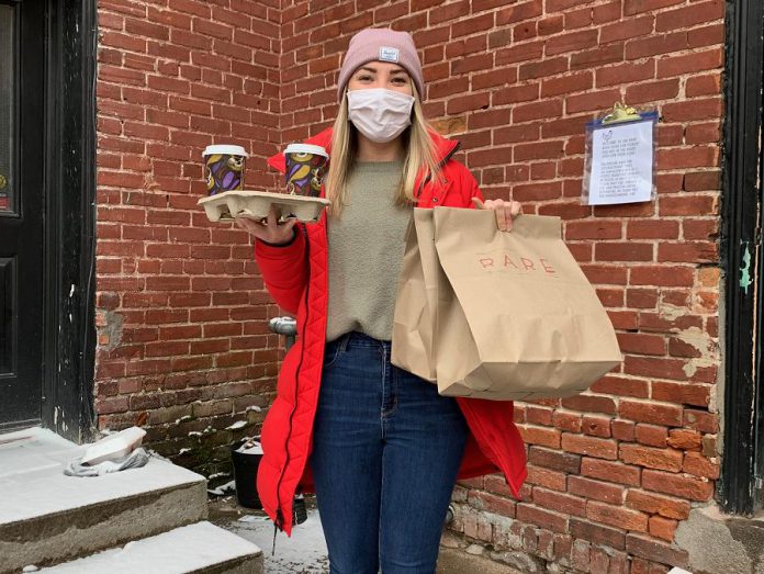 Rare employee Christina picking up food at Rare's back door. Throughout the lockdown, all Rare employees eat for free.  (Photo courtesy of Rare)