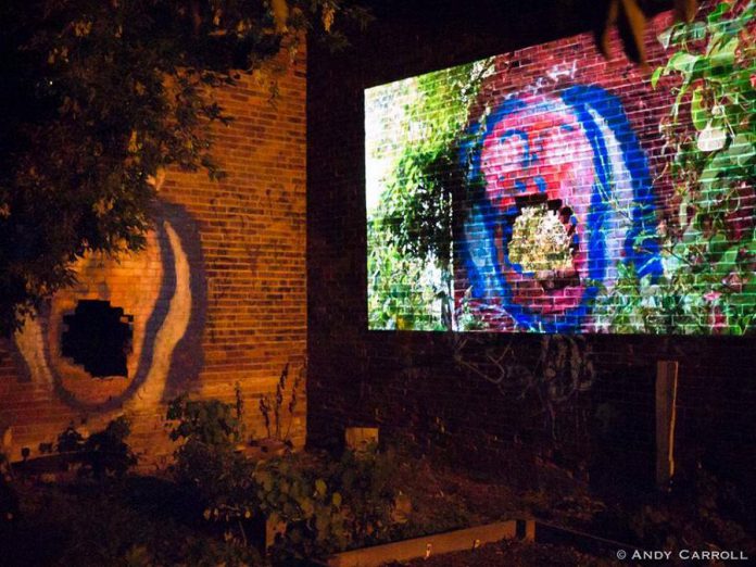 Peterborough-area artists can now apply for funding for Artsweek SHIFT2, a "pocket festival" of the arts running from March to May in advance of the full Artsweek festival scheduled for fall 2021. Pictured is "The Door That You Walk Through", a film by Daniel Crawford projected onto the side of an abandoned brick building behind The Only Café, during Artsweek 2018. (Photo: Andy Carroll)