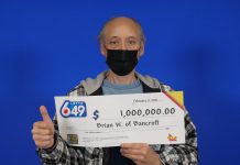 Brian Woodcox of Bancroft gives a thumbs up as he collects his $1 million cheque in Toronto. (Photo courtesy of OLG)