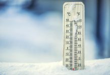 Thermometer on snow showing extreme cold temperature of more than -30C. (Stock photo)