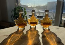 The winter sun shining through bottles of maple syrup at the GreenUP Store in Peterborough. Unless appropriate action is taken to mitigate the impacts of climate change, sugar bushes may no longer be viable in southern Ontario due to drought. (Photo: Kristen LaRocque)