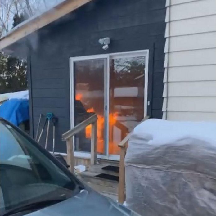 Lindsay man John Mcdonald was walking in the neighbourhood when he discovered a house was on fire. After calling 911, he realized a dog was trapped in the home. (Facebook video screenshot)