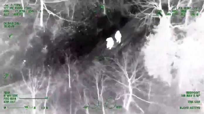 The OPP Aviation and Emergency Response Team locate two hikers lost in Queen Elizabeth II Wildlands Provincial Park on March 5, 2021. (OPP video screenshot)