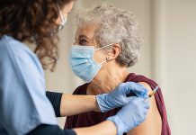 An older woman receiving a COVID-19 vaccination. (Stock photo)