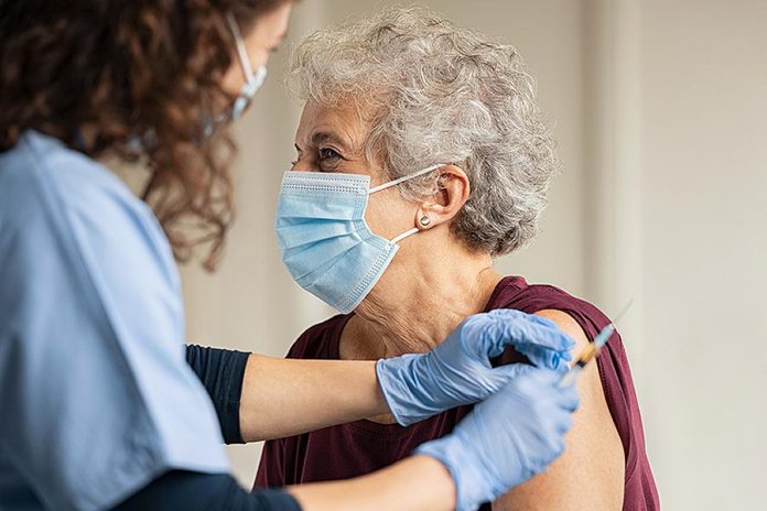 An older woman receiving a COVID-19 vaccination. (Stock photo)