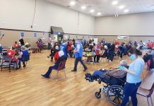 Due to increasing supplies of the Pfizer vaccine, Ontario will be expanding vaccine eligibility to everyone 18 years and older by the end of May. Pictured are Peterborough-area residents 80 years of age and older receiving their first doses of the Pfizer vaccine at the COVID-19 immunization clinic at Evinrude Centre in Peterborough on March 21, 2021. (Photo: Jeannine Taylor / kawarthaNOW)