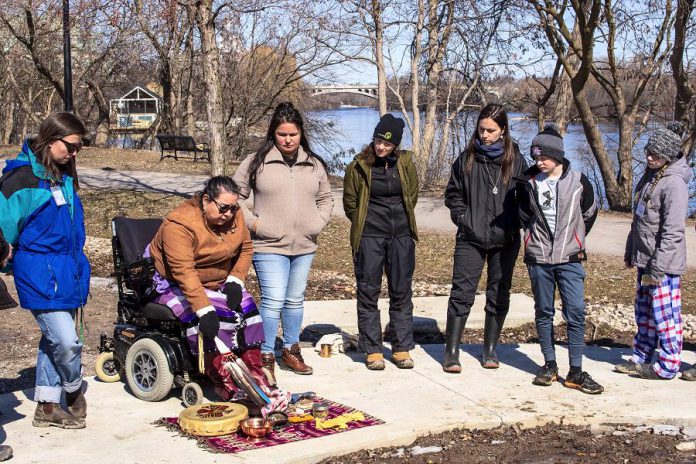 Before the pandemic hit in 2020, Elder Dorothy Taylor of the Curve Lake First Nation explains the significance of the materials she uses to perform an Anishinaabe Water Ceremony as students from St. Anne's Catholic Elementary School listen. This was part of a watershed tour with GreenUP's Wonders of Water program. (Photo: Leif Einarson)