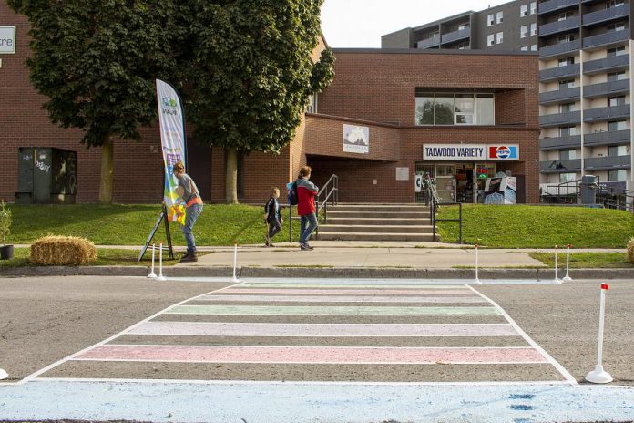 Accessibility and safety must be top priorities when designing neighbourhoods and cities that encourage more active forms of transportation. This temporary pop-up infrastructure project in the Talwood neighbourhood in October 2020 demonstrates how a crosswalk could provide safe access to this convenience store, if an accessible ramp were also included at the curb. (Photo: Leif Einarson)