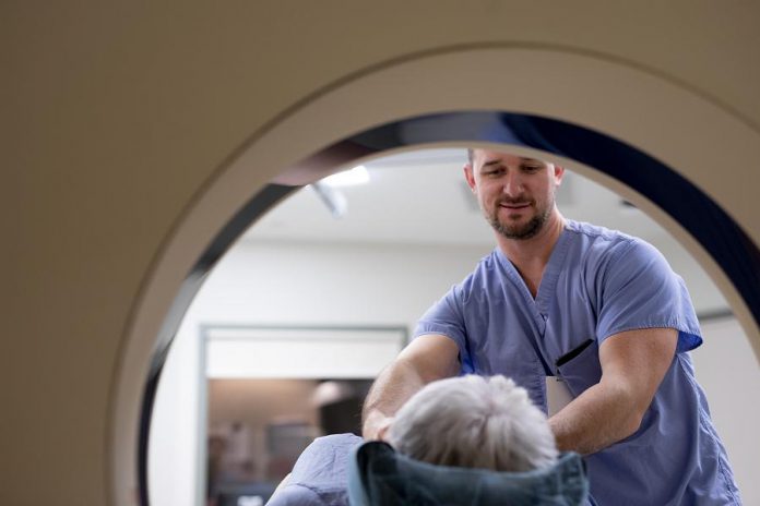 In this photo taken prior to the pandemic and universal masking protocols, a medical radiation technologist and volunteer demonstrate the current CT scanner technology at Peterborough Regional Health Centre. CT scan technology has greatly improved in the past decade. New CT scanners are faster (meaning shorter scan times), provide higher quality images, and use less radiation -- meaning less risk to the thousands of patients who will be scanned every year at Peterborough Regional Health Centre. (Photo: Michael Hurcomb)