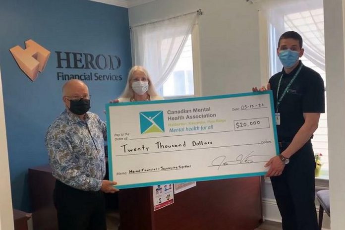 Kevan and Roberta Herod present a cheque for $20,000 to Jack Veitch of Canadian Mental Health Association Haliburton, Kawartha, Pine Ridge. (Facebook video screenshot)