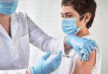 A teenage boy receiving a vaccination. (Stock photo)