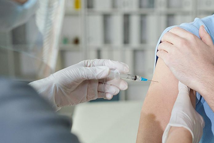 Close-up of a person receiving a vaccination. (Stock photo)