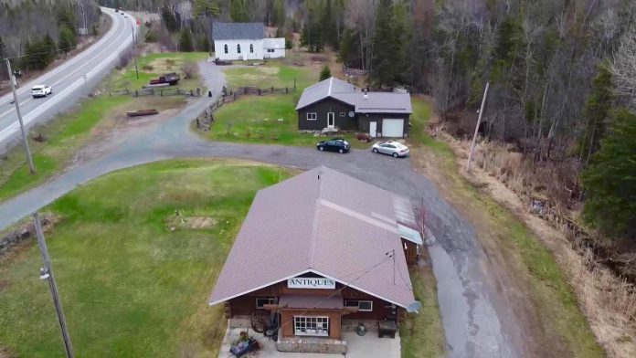 Kawartha Adventure Rentals has purchased the Woodview property from East of Eden Antiques owner Brenda Mahaffy. As part of the deal, East of Eden Antiques will continue to operate out of the white church on the property. (Screenshot from Facebook video by kawarthaNOW)