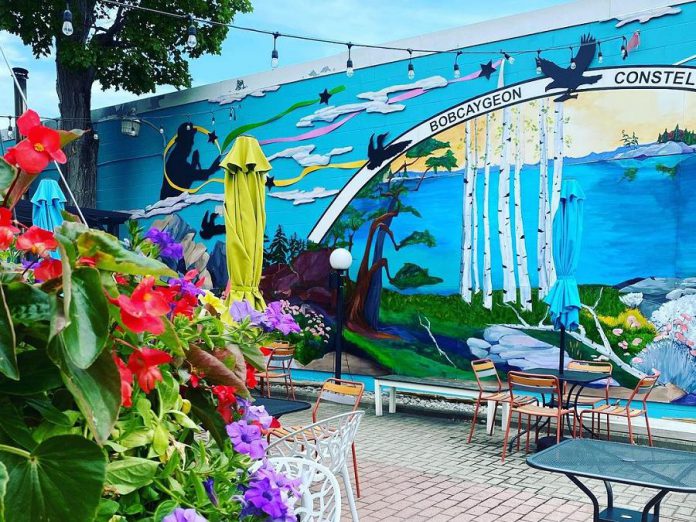 The Bobcaygeon Constellation mural at El Patio, by Fenelon Falls artist Penni Holdham, was commissioned by El Patio owner Kathleen Seymour-Fagan in 2018. Named after The Tragically Hip's famous song "Bobcaygeon", the mural depicts Bobcaygeon with constellations represented in Anishinaabe symbols and includes a silhouette of the late Tragically Hip frontman Gord Downie. (Photo courtesy of Kathleen Seymour-Fagan)