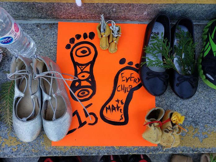 Tributes left on the steps of Peterborough City Hall. (Photo: Jeannine Taylor / kawarthaNOW)