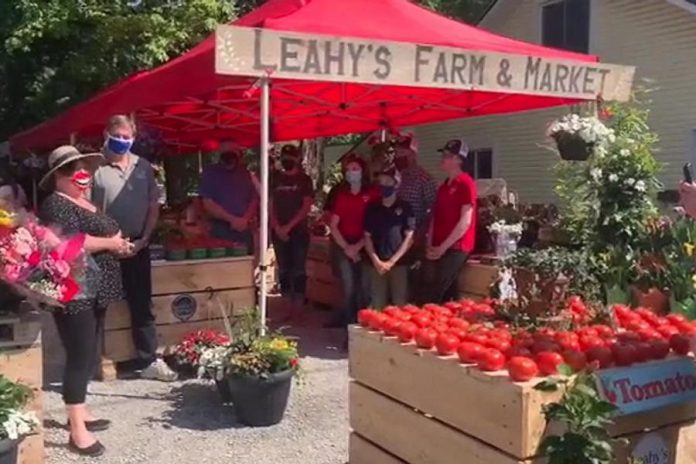 During the launch of the new Leahy's Farm & Market in Apsley on June 4, 2021, North Kawartha Mayor Carolyn Amyotte (far left) thanked Peterborough-Kawartha MPP Dave Smith (second from left) for the delivery of 3,000 pounds of food and $1,250 in cash donations and gift cards for the North Kawartha Food Bank, raised earlier in the day at Morello's Your Independent Grocer in Peterborough. Leahy's Farm & Market is a partnership between the Leahy family, Ball Real Estate, and Calm N Ground. (Screenshot of Facebook video by Ball Real Estate)